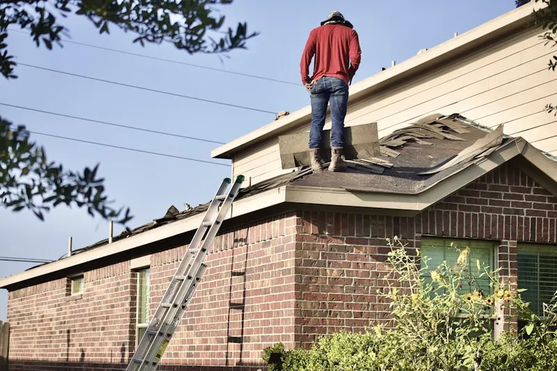 Professional roofer working on a residential roof in Bucksville